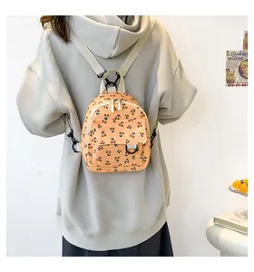 Mini corduroy backpack featuring navy cherry print and adjustable off-white fabric straps
