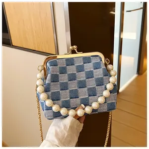Blue checkerboard denim crossbody bag with pearl handle and golden metal frame