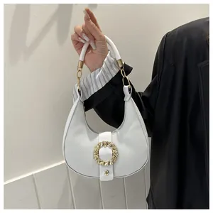 Close-up of a white hobo bag featuring lychee texture and a gold metal ring clasp