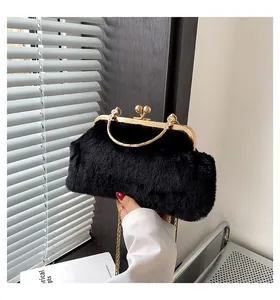 Close-up of fluffy black faux fur bag with golden frame, clasp, and handle detail