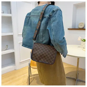 Détail du sac bandoulière vintage avec motif marron et bandoulière ethnique