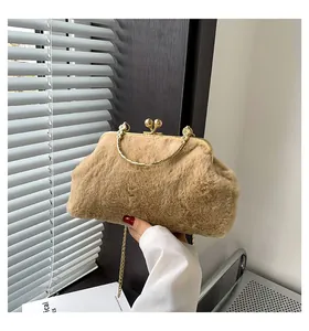 Close-up of plush faux fur handbag with golden kiss-lock and elegant chain strap