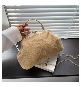 Detailed shot of khaki faux fur bag with golden circular handle and floral metal accents