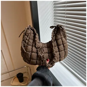 Détail du sac nuage marron foncé matelassé avec bandoulière froncée et nœuds décoratifs