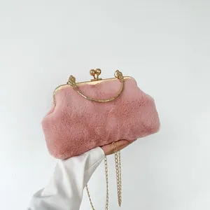 Detail of plush faux fur texture and vintage metal clasp on pink crossbody bag