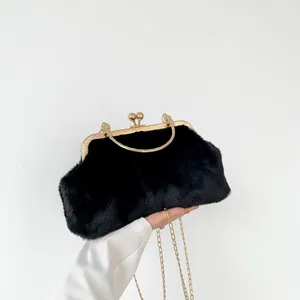 Detail of black faux fur bag featuring a gold vintage clasp and sleek chain strap
