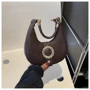 Detail of hobo bag with gold textured buckle and premium brown lychee pattern leather