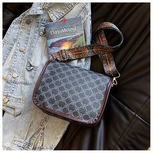 Détail du sac bandoulière vintage avec motif trèfle et large sangle tissée ethnique