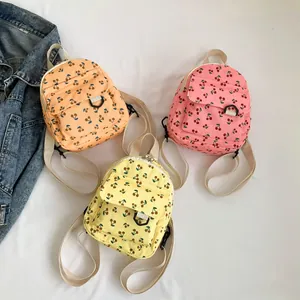 Three corduroy mini backpacks for kids featuring cute cherry embroidery and front pockets