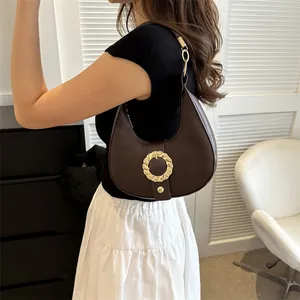 Retro brown leather hobo bag with unique gold wave buckle for women's autumn style