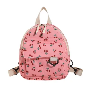 Pink corduroy mini backpack for women and kids with red cherry print and white straps