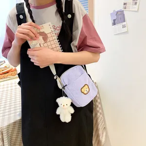Cute lavender corduroy crossbody bag with bear embroidery and plush charm for girls
