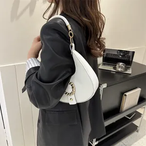 Minimalist white crescent shoulder bag with lychee texture and gold ring buckle