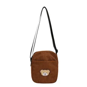 Cute brown corduroy bear crossbody bag for kids with adjustable strap on white background