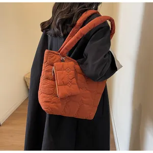 Dettaglio borsa shopper trapuntata arancione con piccola pochette coordinata con zip