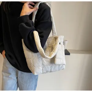 Dettaglio della borsa tote trapuntata beige con imbottitura morbida e piccolo borsellino