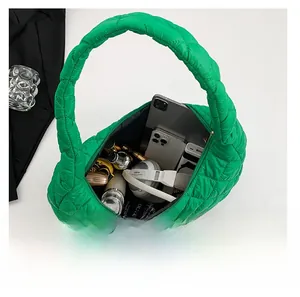 Top view of bright green quilted shoulder bag showing spacious storage for essentials