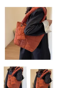 Dettaglio della borsa tote trapuntata arancione caramello con cuciture esagonali imbottite