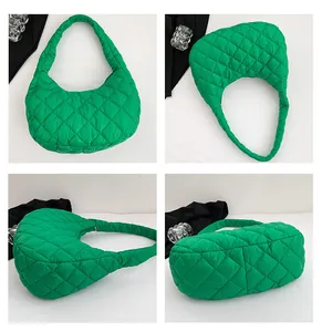 Detail view of green quilted crescent bag showing the diamond stitching and spacious interior