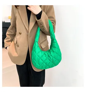 Fashionable bright green quilted cloud bag styled with a brown blazer for autumn style