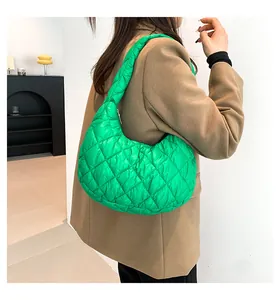 Detail of bright green quilted hobo shoulder bag showing puffy diamond stitch texture
