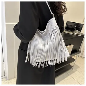 Detail showing Bohemian light grey fringe shoulder bag with long tassel accents