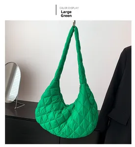 Close-up of a large green quilted puffer shoulder bag with stylish diamond pattern