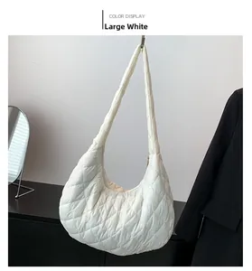 Detail of large white cloud bag showing quilted diamond stitching and padded nylon texture