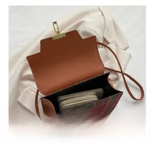 Detailed interior view of a vintage plaid crossbody bag showing storage capacity and flap