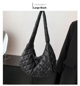 Detailed view of large black quilted cloud tote bag with puffy diamond stitching