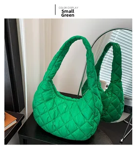 Detailed view of a small green quilted hobo bag with cloud-like padding and diamond stitching
