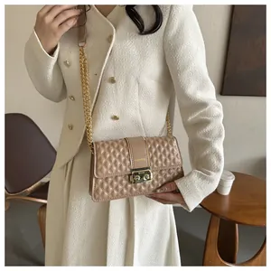 Détail du sac bandoulière beige matelassé avec chaîne dorée et fermoir métallique chic