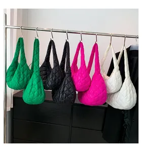 Detailed quilted texture of oversized cloud shoulder bags in multiple vibrant colors