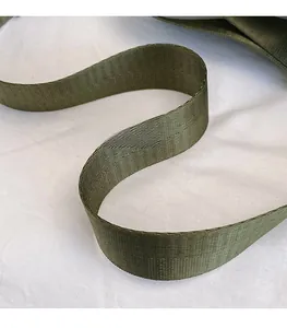 Detail of army green nylon woven shoulder strap with smooth texture and high gloss finish