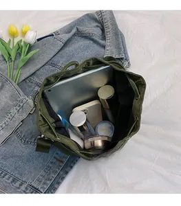 Interior view of green bucket bag showing large capacity for tablet and skincare items