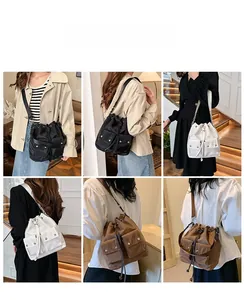 Detail view of nylon bucket bags with drawstring closure and metal snap front pockets