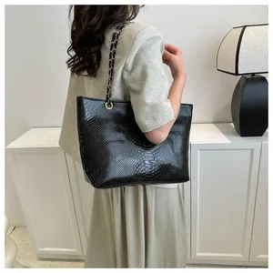 Detail of black faux animal texture on large tote bag with metallic chain strap