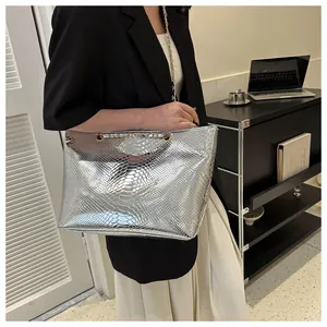Macro view of silver snakeskin embossed tote bag with elegant thin chain strap detail