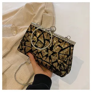 Detailed shot of vintage evening clutch with geometric gold sequins and crystal-encrusted ring