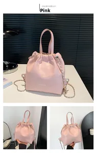 Detail of pink quilted bucket bag with chain strap and drawstring closure
