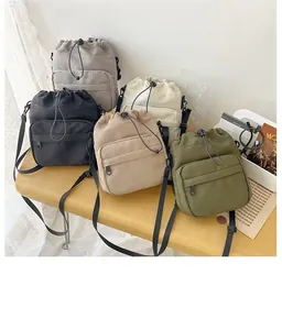 Detailed display of five colorful nylon bucket bags with drawstring and zipper pocket