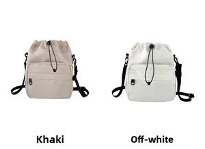 Detail of khaki and off-white waterproof nylon bucket bags with drawstring and zipper pocket