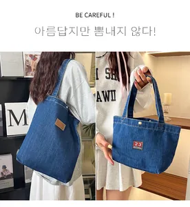 Detail of blue denim tote and handbag with vintage Cowboy bag embroidery and label