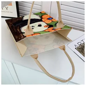 Detail of artistic panda and floral pattern on the beige felt tote bag open top view