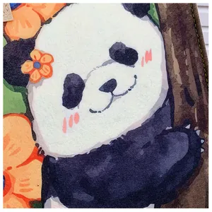 Detailed macro shot of giant panda watercolor print on felt tote bag with yellow stitching