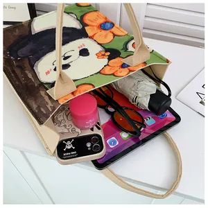 Internal storage of panda felt tote bag showing tablet, umbrella and daily essentials