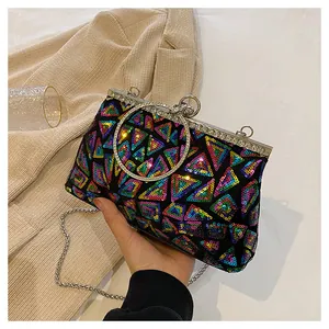 Detail of evening clutch with colorful sequins, metal ring handle, and rhinestone frame