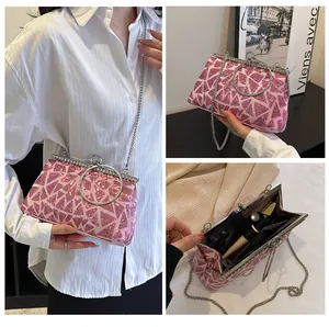 Close-up of pink sequin clutch with metal ring handle and crystal kiss-lock closure