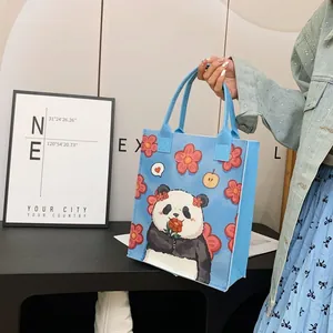 Blue tote bag featuring cute panda and flower illustrations for daily commuting