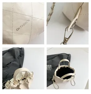Macro detail of beige quilted leather bucket bag showing hardware and texture